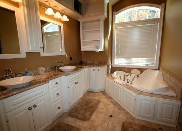 Custom cabinetry with stone tops in a bath space